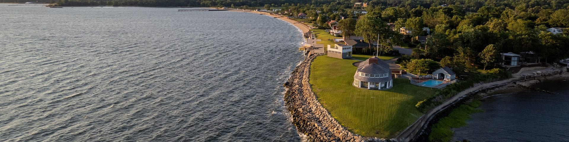 Aerial view of sunrise on island with green lawn and resort houses of Long Island, New York
