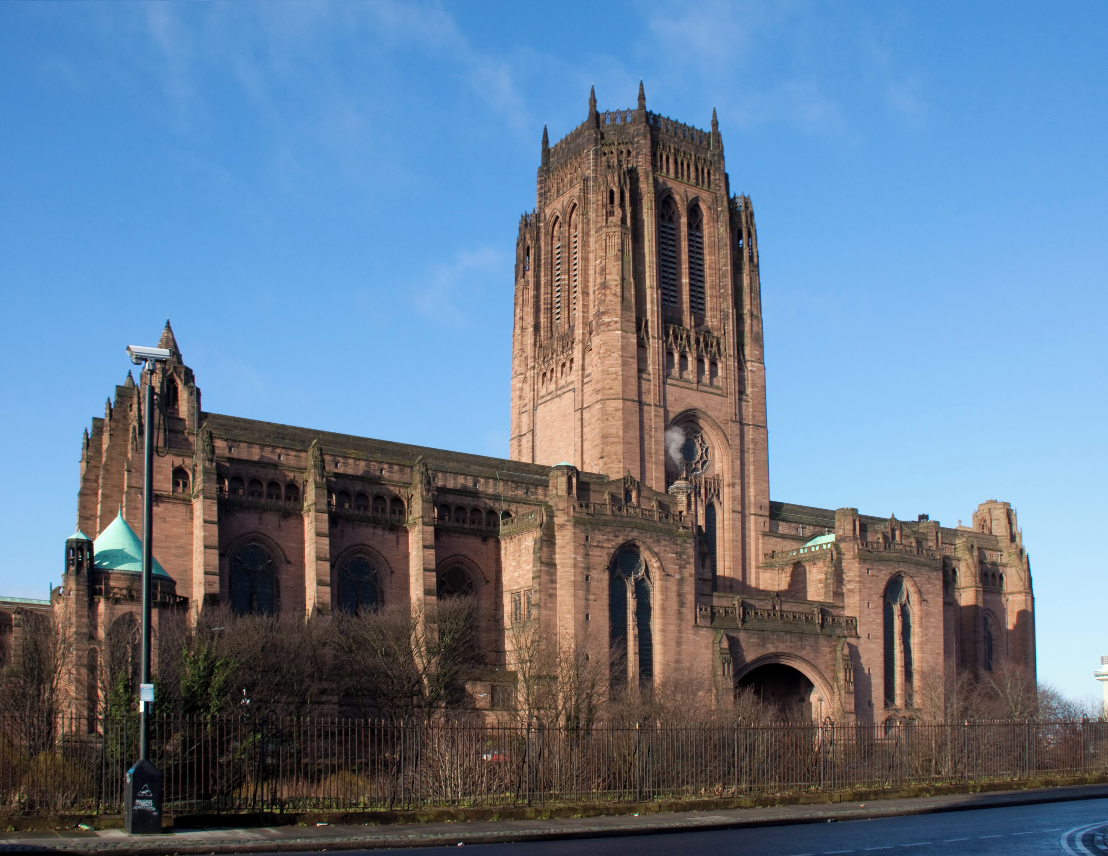A large historic cathedral with a tall central tower and multiple arches.