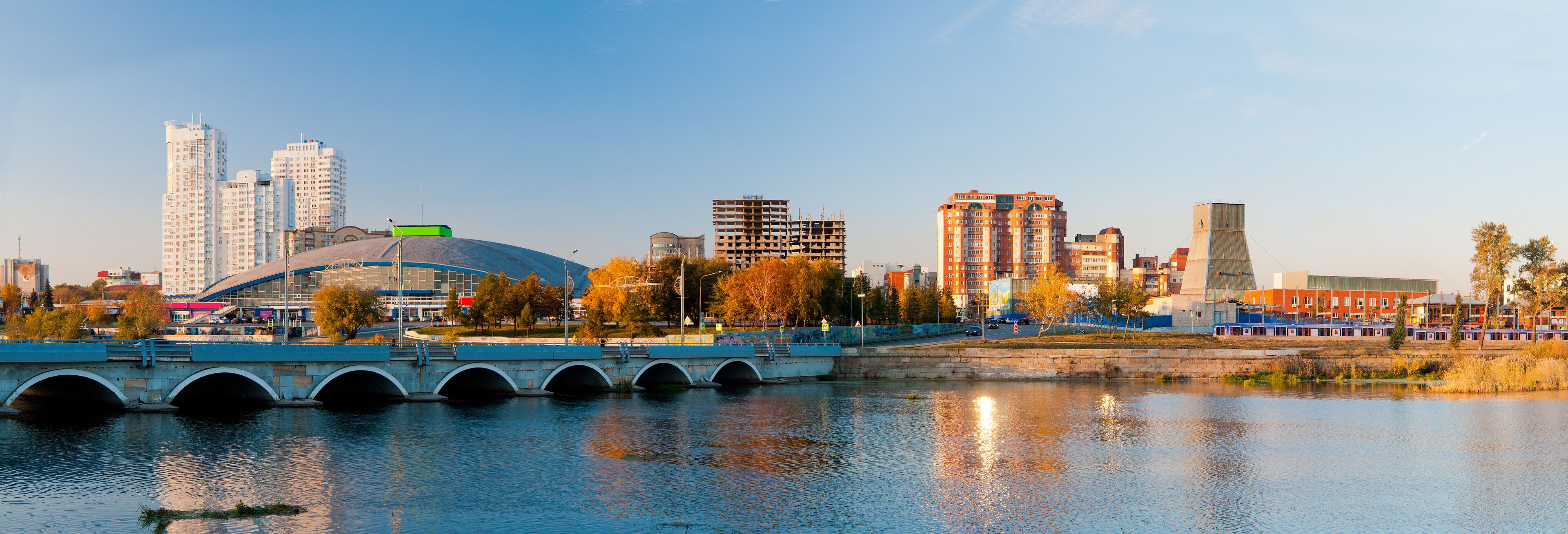 Panorama of the autumn embankment of the river Miass
