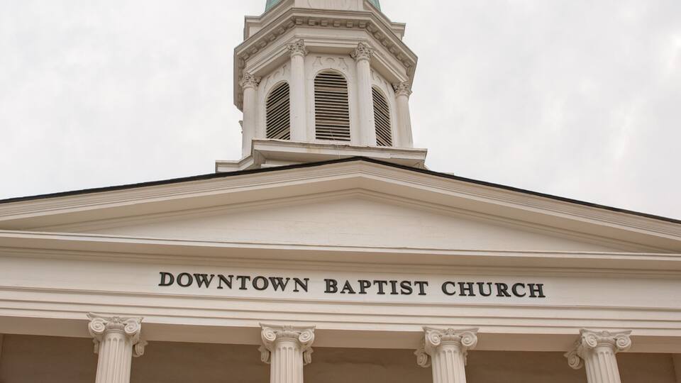 The Downtown Baptist Church facade with columns and a steeple.