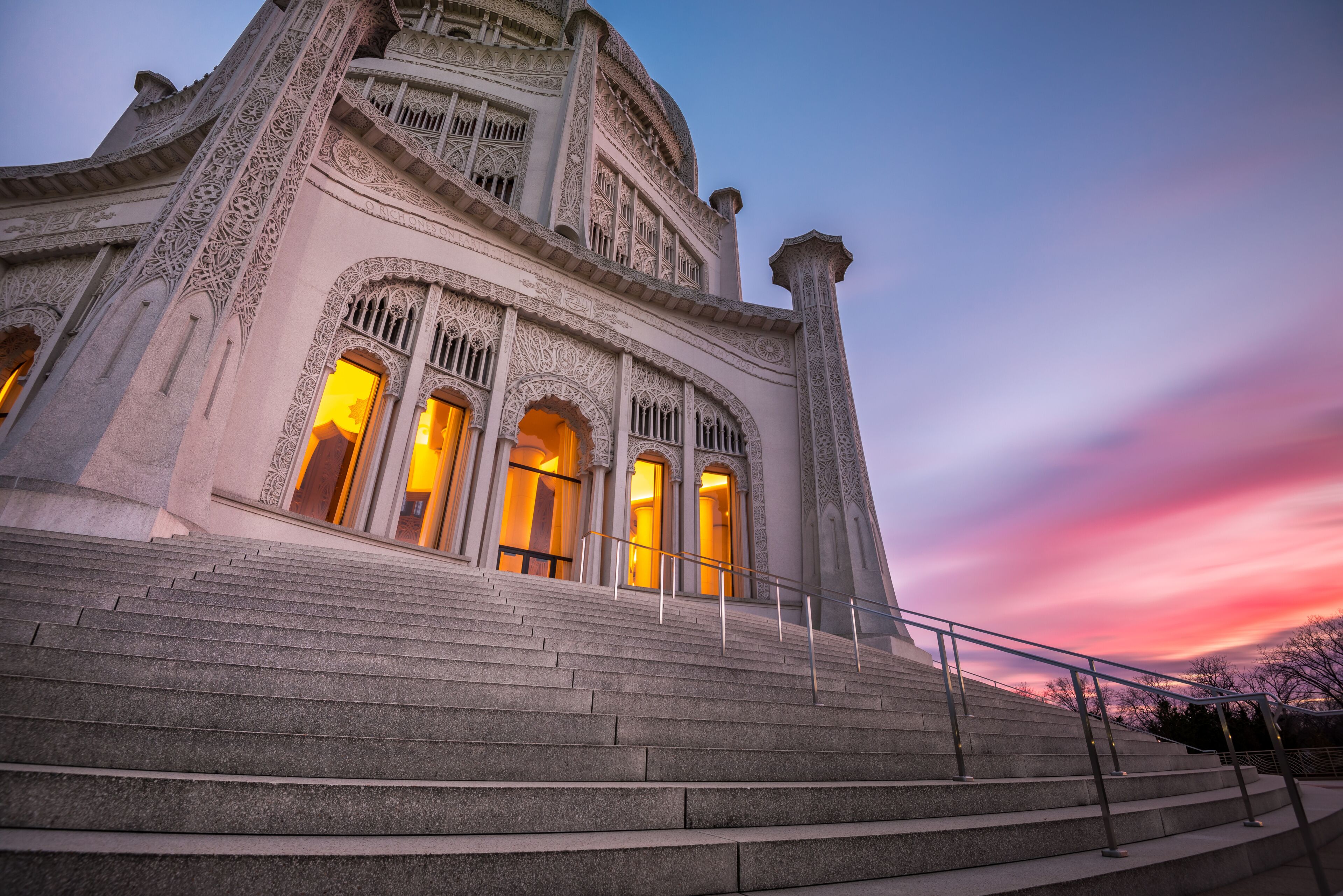 A grand building with ornate architecture and a staircase leading up to it.