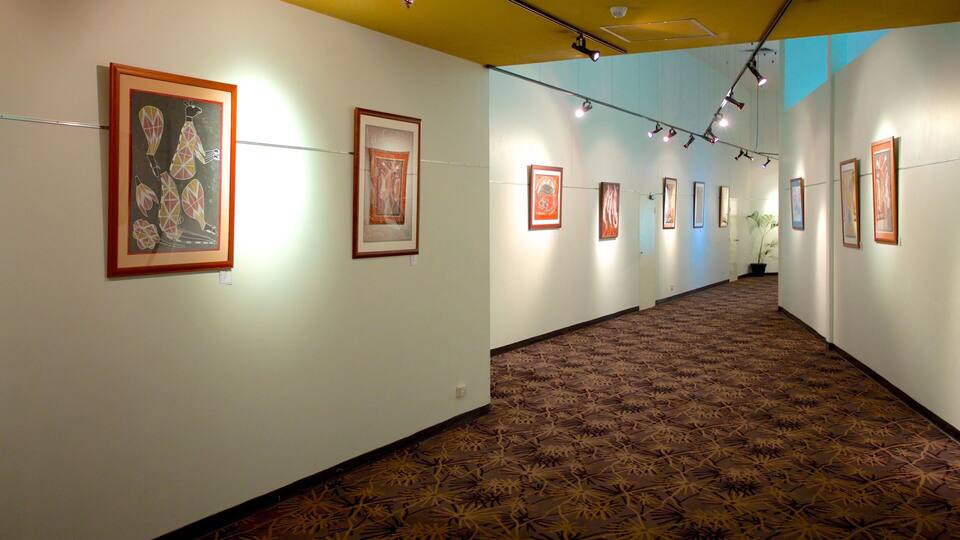 A gallery with framed artworks on the walls and a patterned carpet on the floor.