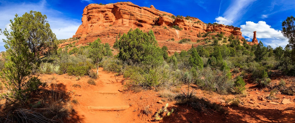 A red rock formation with a clear sky.