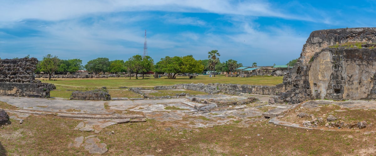 Ancient ruins with stone structures and a clear sky.
