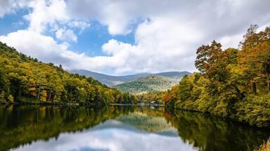 wide open landscape with lake and mountains and cloud with sky reflecting in water at vogel state park in Georgia