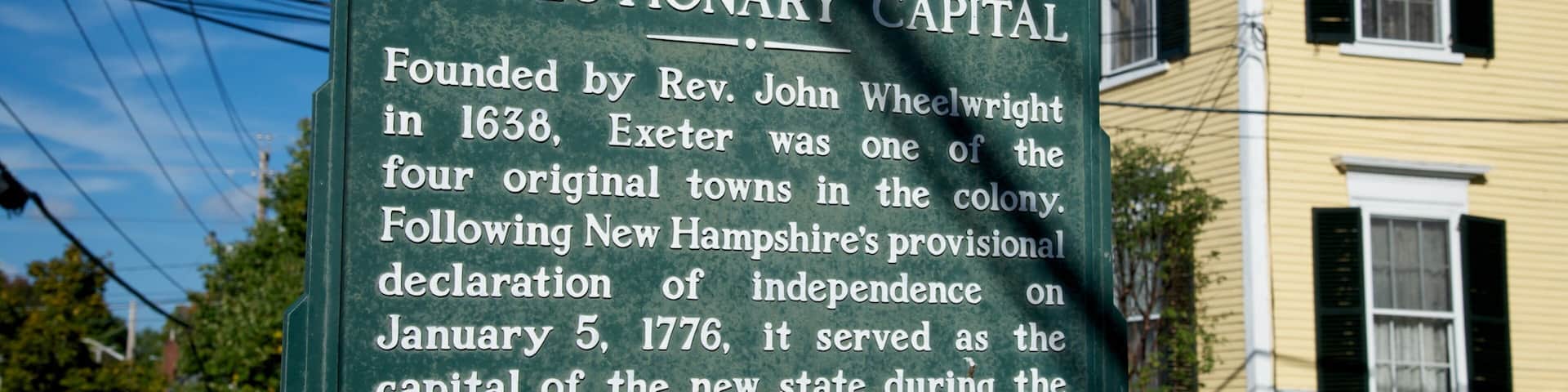 A historical sign about Revolutionary Capital, mentioning its founding by Rev. John Wheelwright in 1638 and its role during the American Revolution.