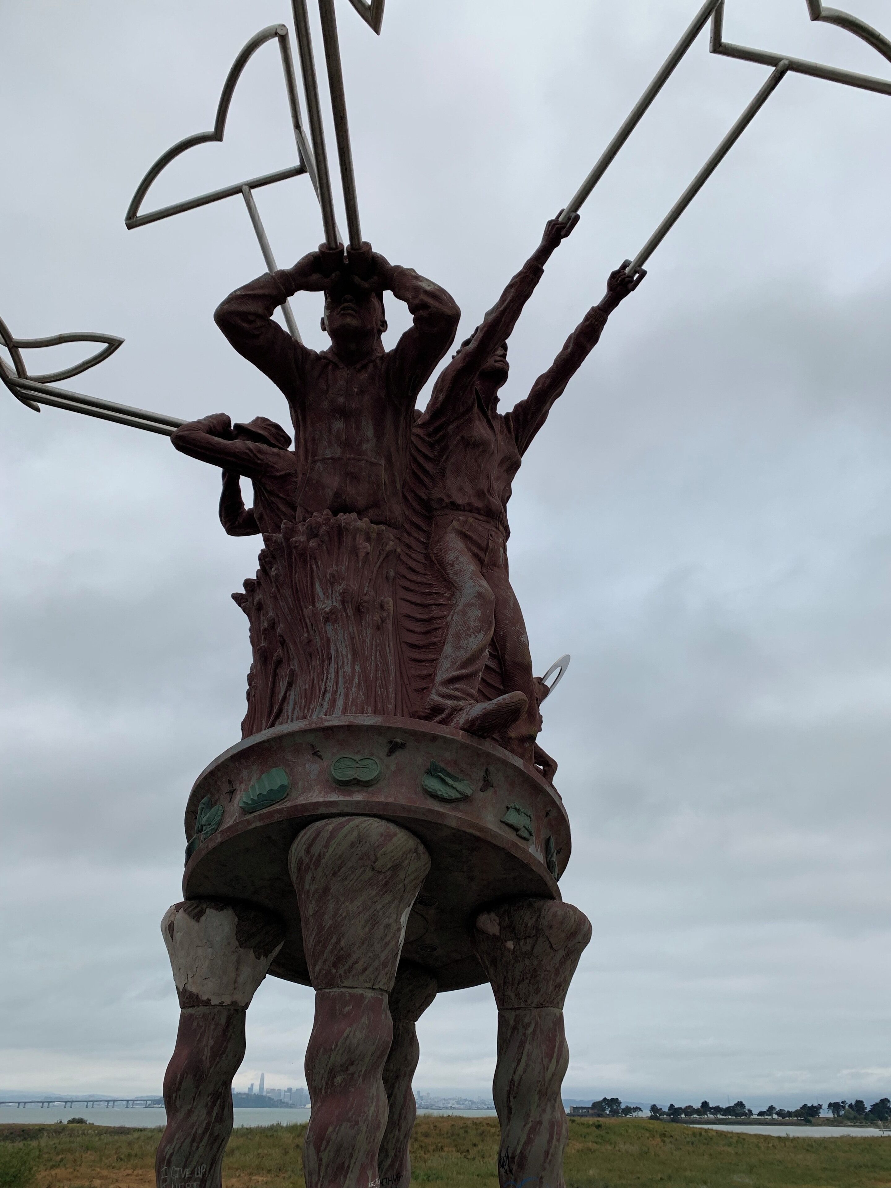 A footbridge runs over the freeway from an aquatic park (small lake) to McLaughlin State Park, which has a preserved wetland and waking trails. This sculpture stands at the western side of the footbridge.