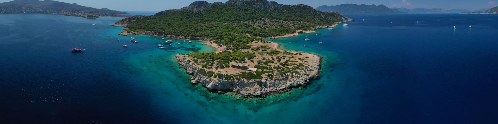Aerial drone photo of secluded paradise bay and small island of Moni with turquoise crystal clear beach next to Aigina, Saronic gulf, Greece
