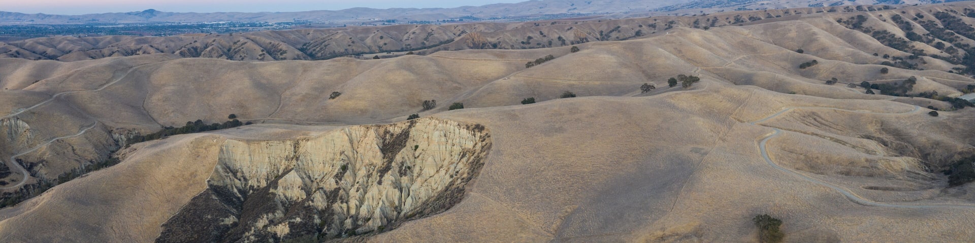 Rolling hills with a prominent cliff face.