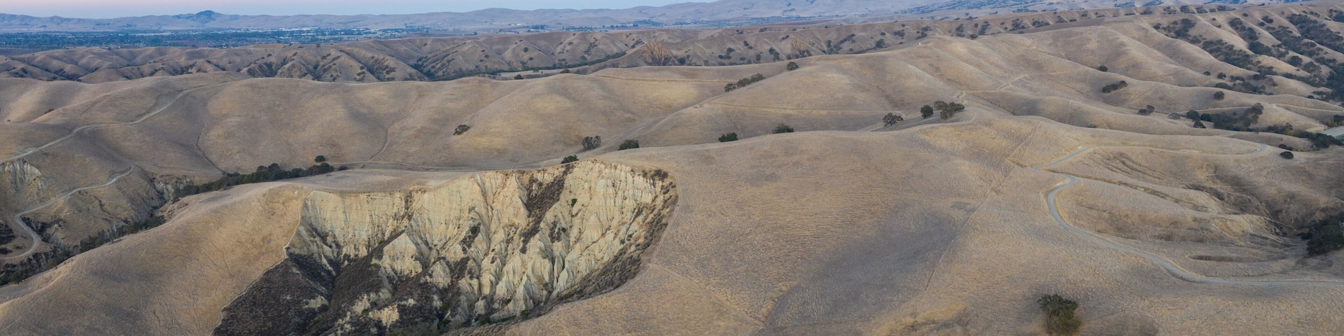 Rolling hills with a prominent cliff face.