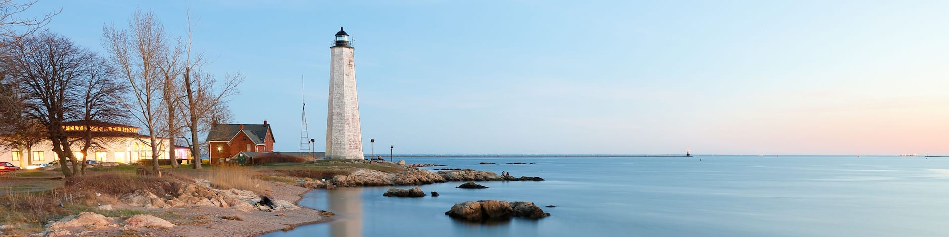 New Haven Light House at Lighthouse Point Park At Sunset. The lighthouse is dark, but the tower remains, greeting ships from around the world to New Haven.