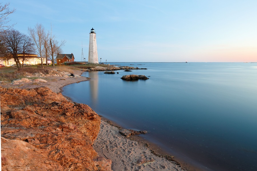 New Haven Light House at Lighthouse Point Park At Sunset. The lighthouse is dark, but the tower remains, greeting ships from around the world to New Haven.