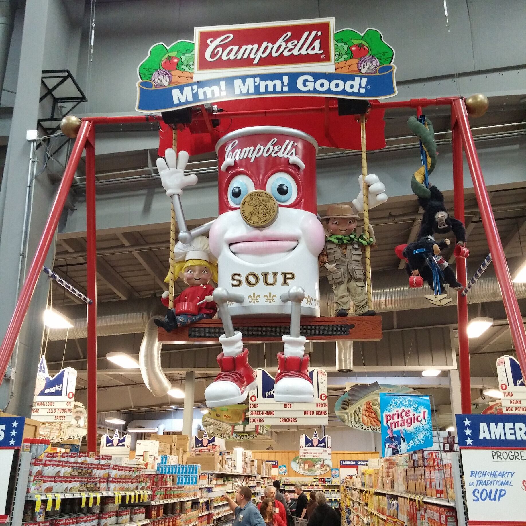 An enormous anthropomorphic can of Campbell's Soup flanked by the Campbell's Kids on a giant playground swings looms overhead. M'm! M'm! Weird! 
Just one of many, many oddities that greet visitors/shoppers of Jungle Jim’s International Market, a 200,000 square feet destination grocery store!