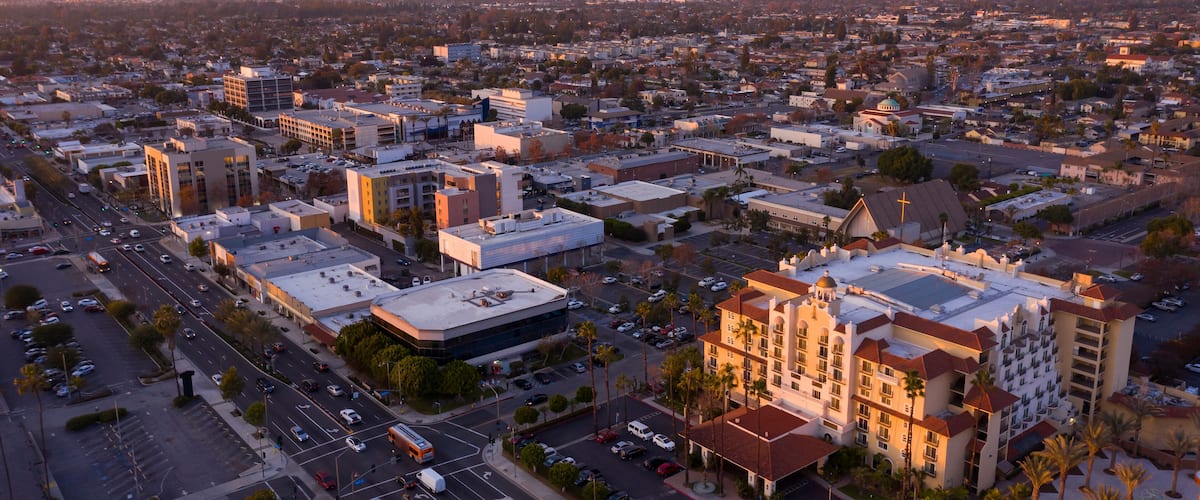 A cityscape with a prominent church and a large hotel.