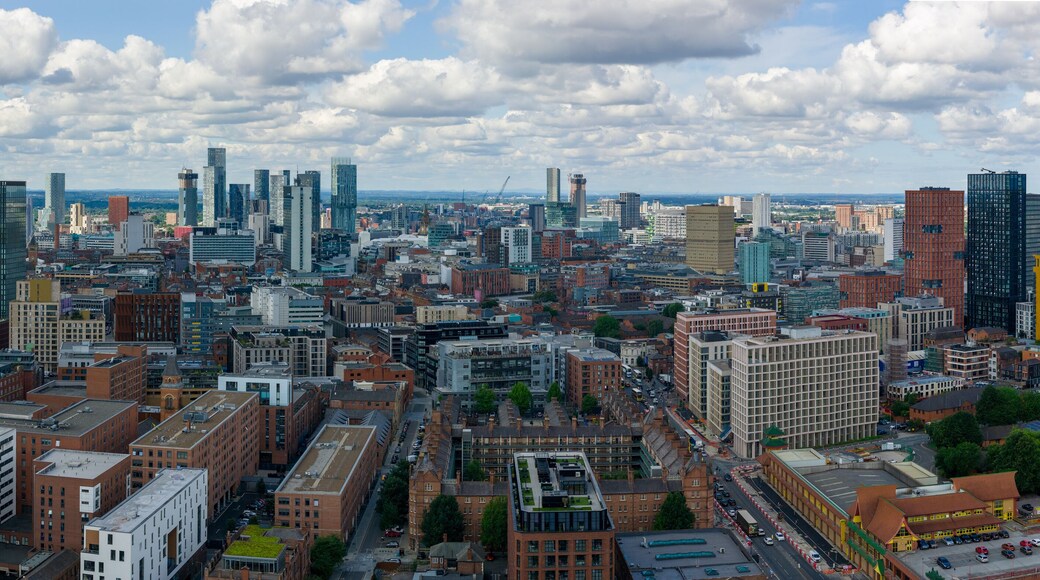 Aerial view of Manchester’s skyline with clustered tall modern towers photographed over Ancoats area.