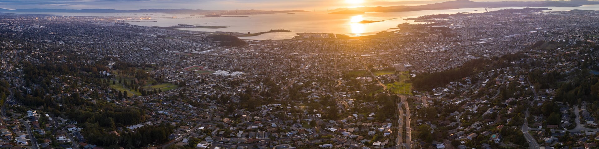 The sun sets over the San Francisco Bay Area in California. This heavily populated region includes the cities of San Francisco, Oakland, Berkeley, Emeryville, El Cerrito, Richmond, and more.