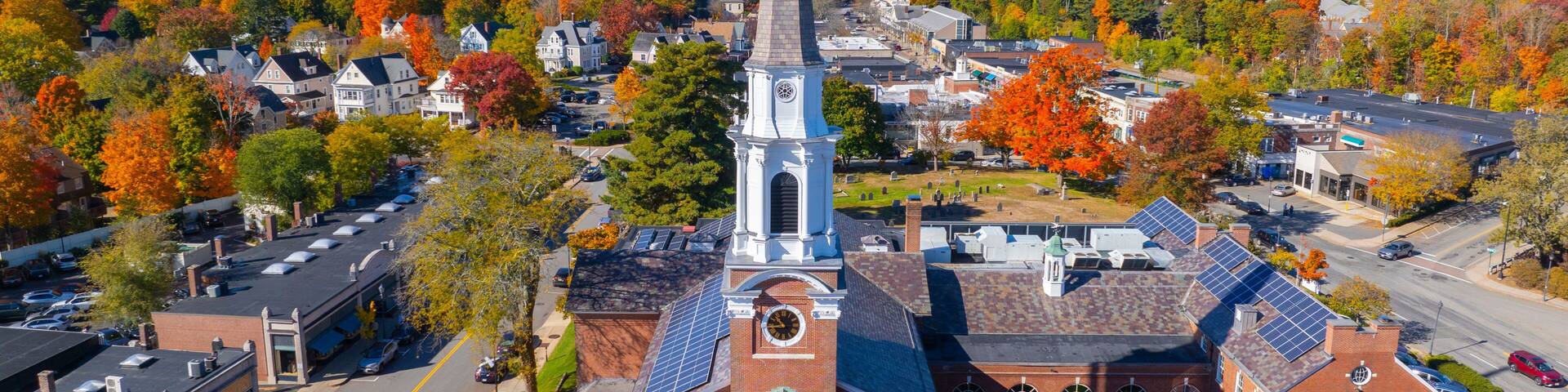 Wellesley Congregational Church aerial view at fall with foliage at 2 Central Street in historic town center of Wellesley, Massachusetts MA, USA.