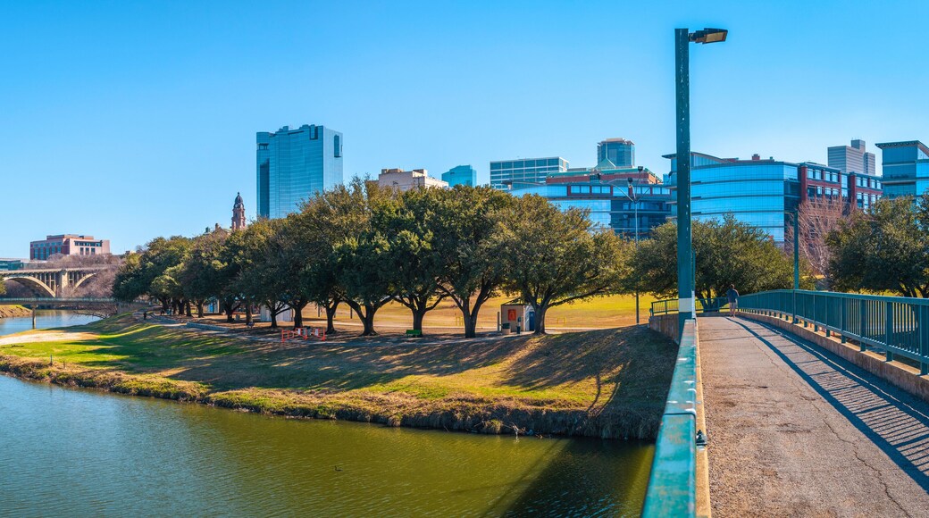 Fort Worth panoramic city skyline, buildings, and walking trails over the Trinity River Bridge, a cityscape with natural open space in Texas