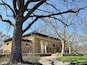 Historic brick pavilion with arched columns in early spring park