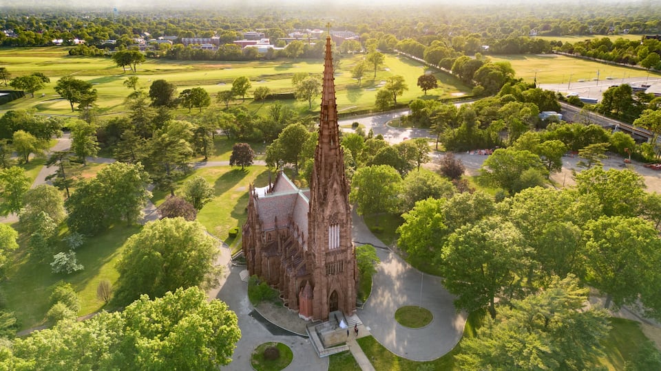 A cathedral surrounded by lush green parkland and a golf course.