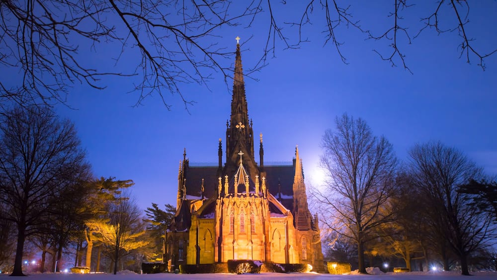 Beautiful cathedral church seen on a snowy winter night with moon glowing in the background. Garden City NY