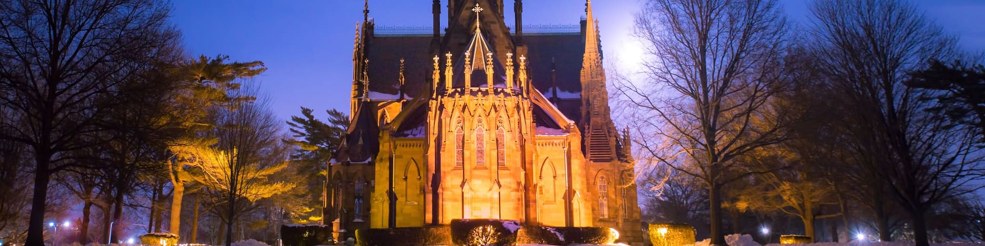 Beautiful cathedral church seen on a snowy winter night with moon glowing in the background. Garden City NY