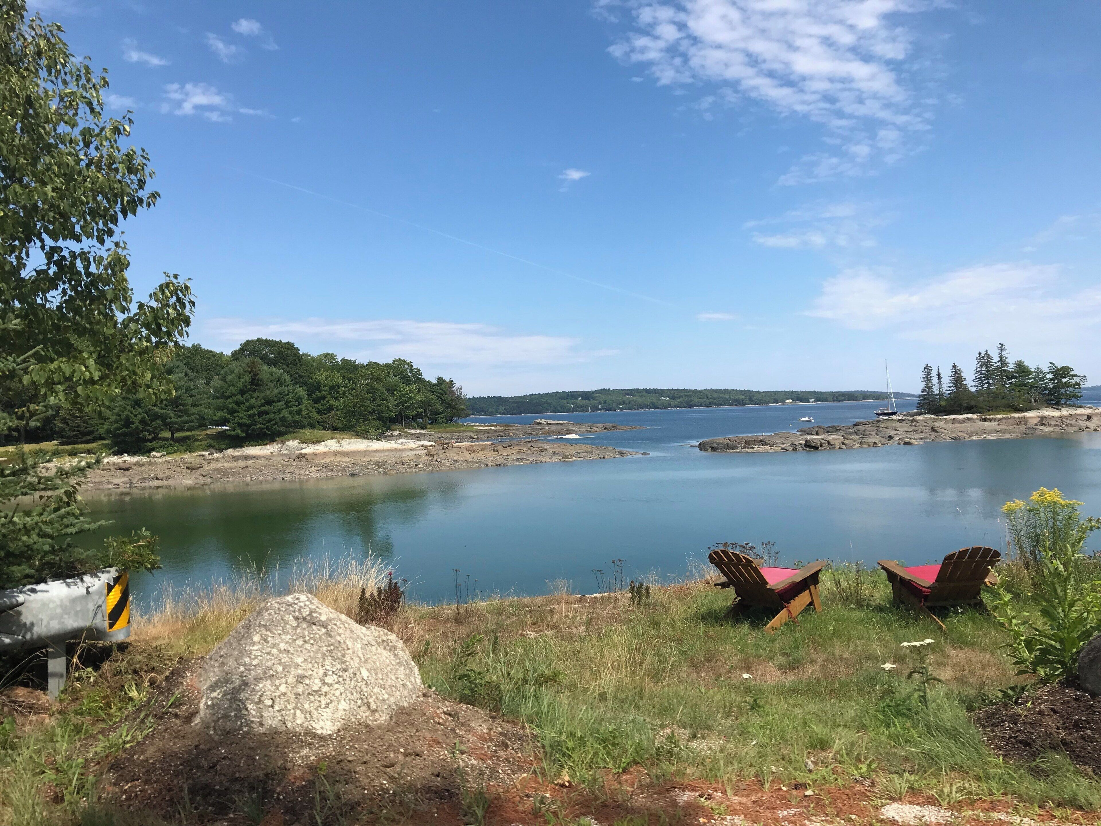 A calm lake surrounded by trees and rocks.