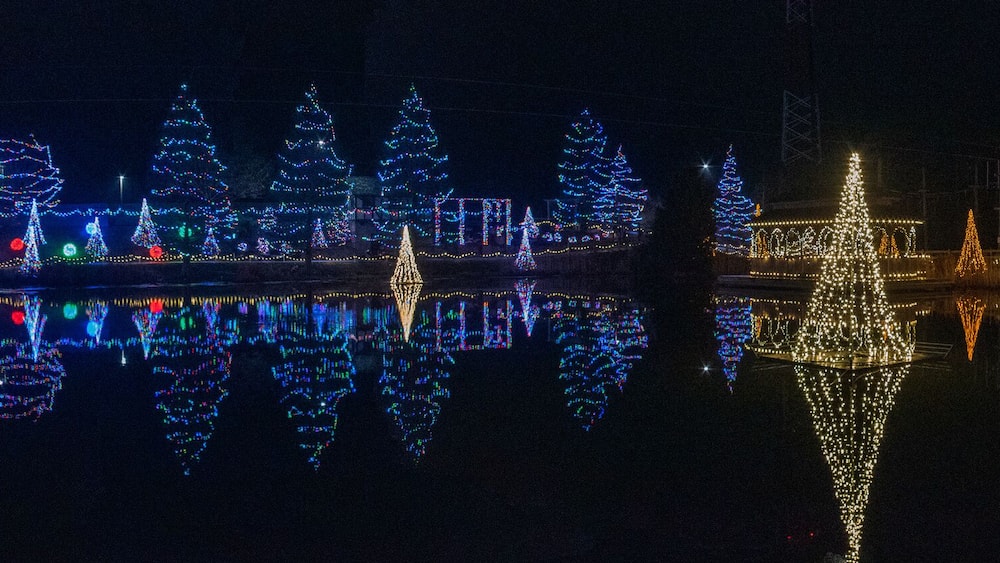 Panorama photo of vivid Christmas lights reflected in water, Florence Kentucky