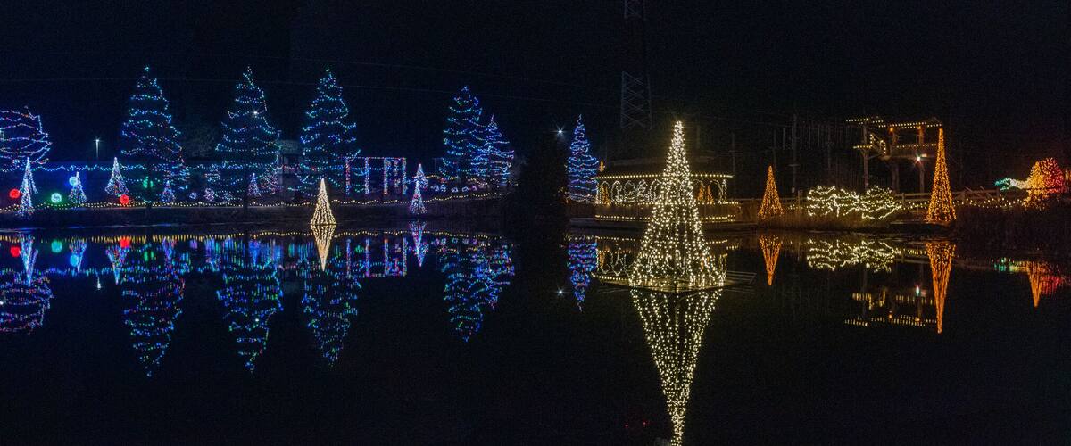 Panorama photo of vivid Christmas lights reflected in water, Florence Kentucky
