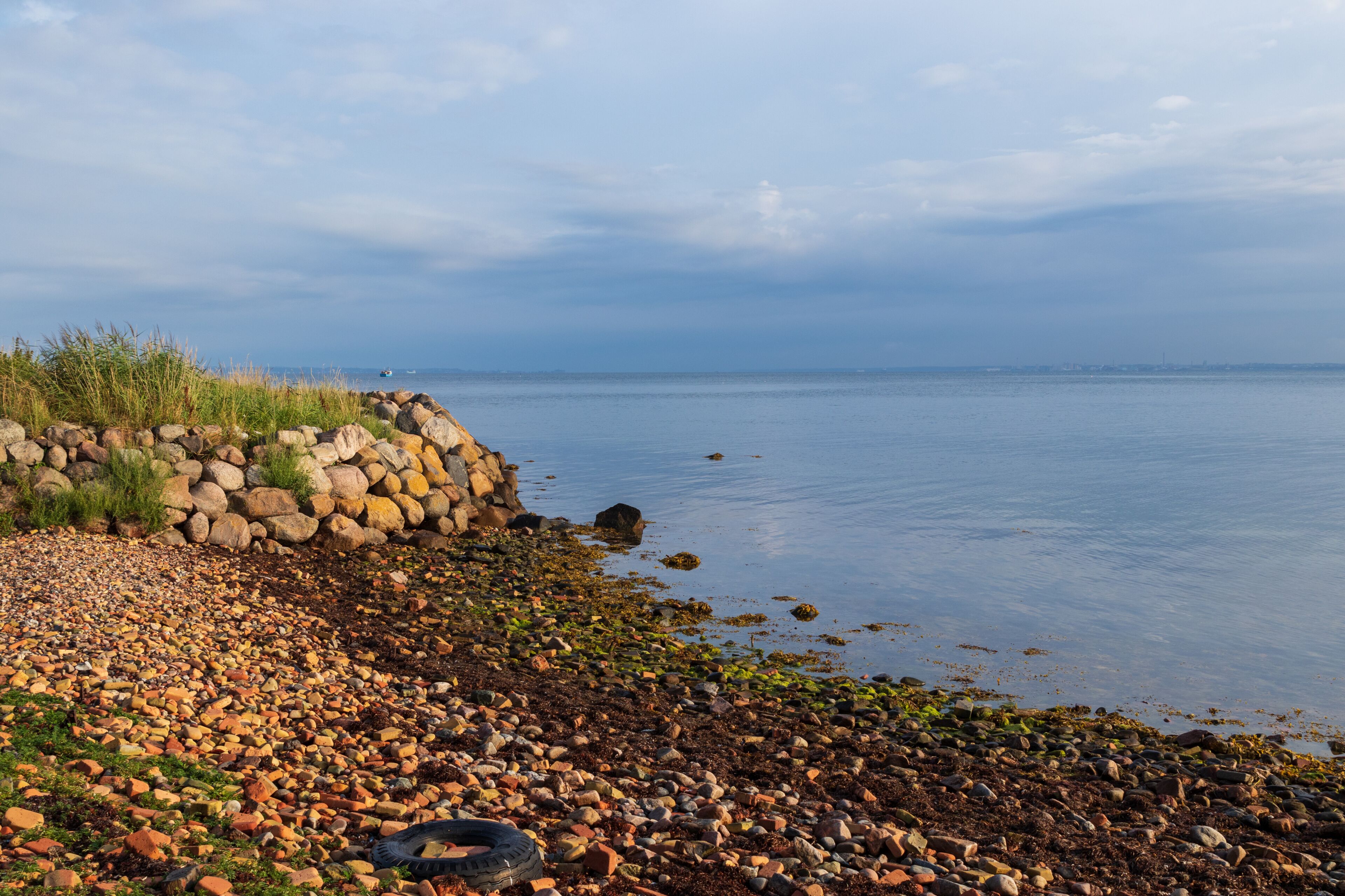 Stone beach on the island of Ven in southern Sweden during a warm summer sunrise. 