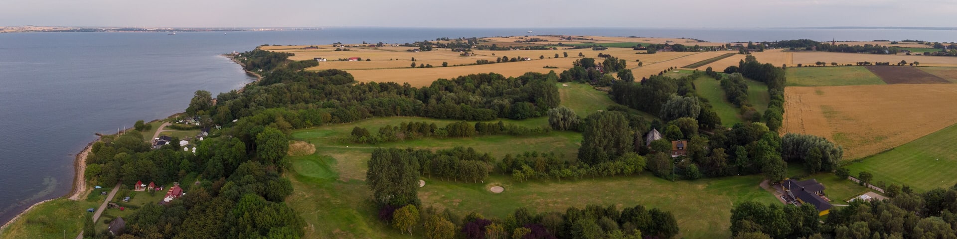 Aerial view of Sankt Ibb golf course on the island Ven in southern Sweden during a summer sunrise.