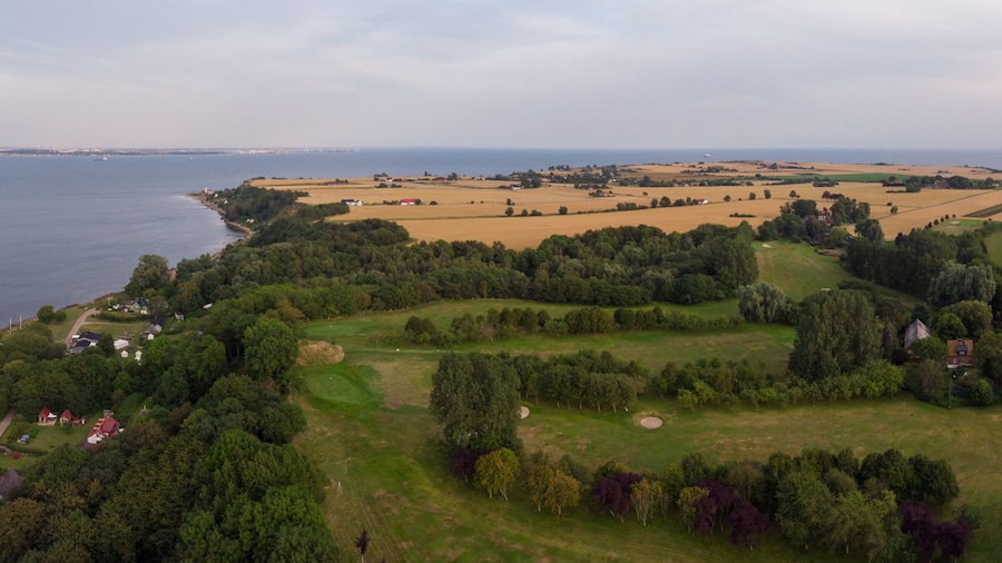Aerial view of Sankt Ibb golf course on the island Ven in southern Sweden during a summer sunrise.