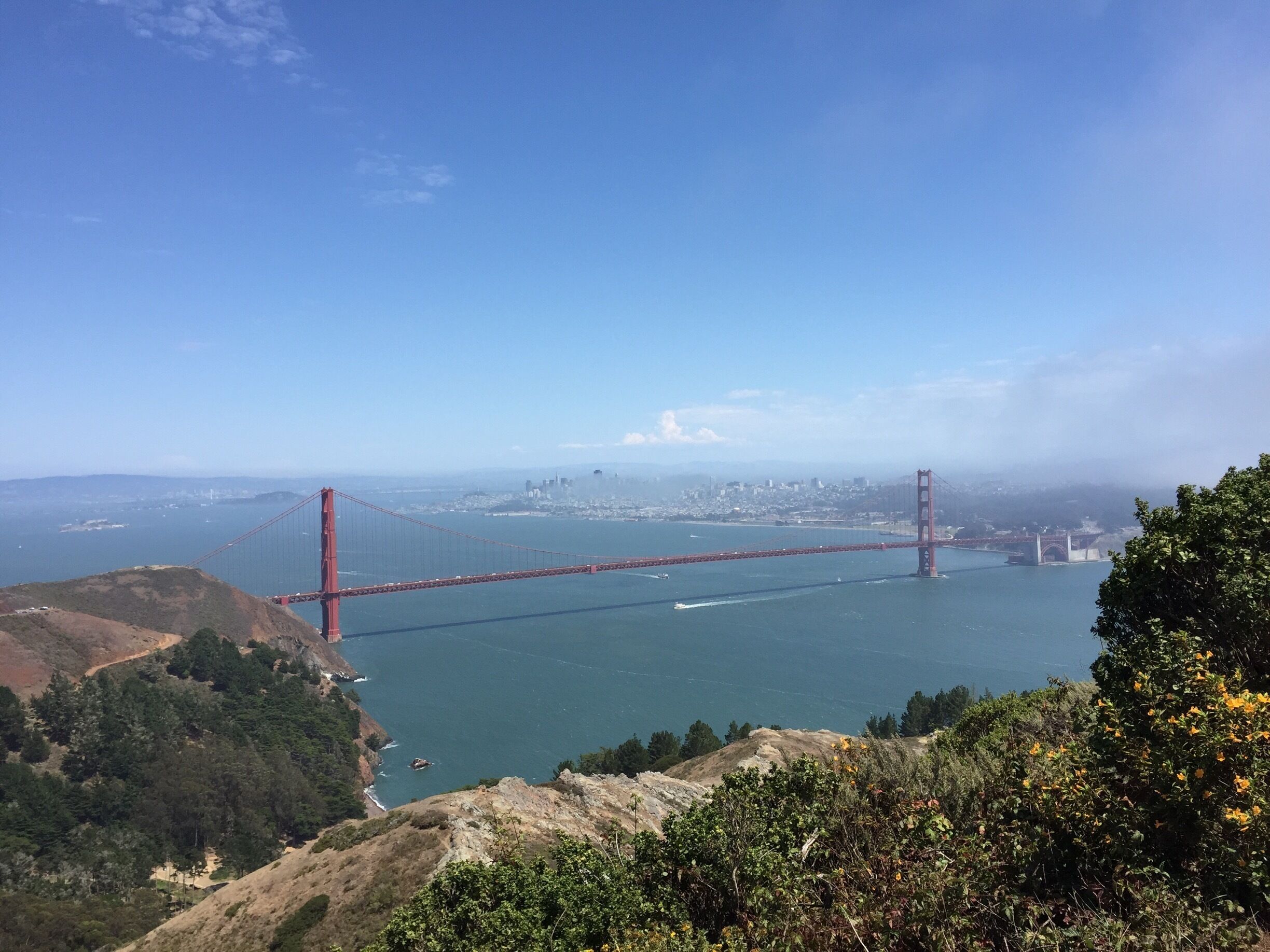 The Golden Gate Bridge spanning a body of water with a cityscape in the background.