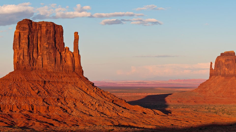 A desert landscape with three prominent rock formations.