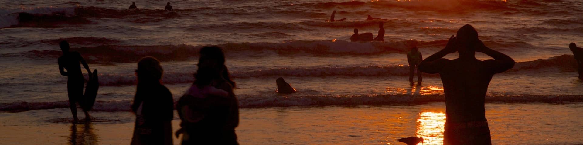 Newport Beach featuring a sandy beach, a sunset and swimming