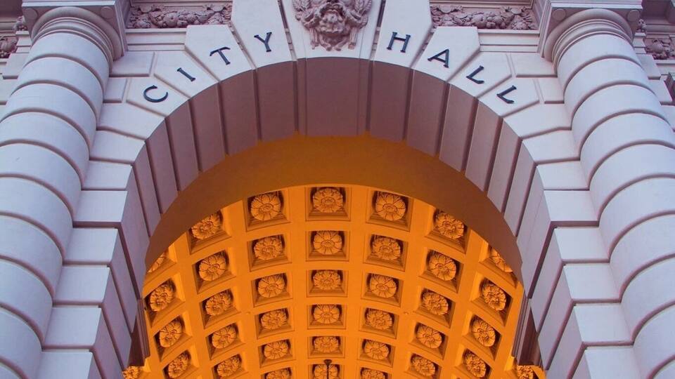 A grand entrance with the words "CITY HALL" and a decorative archway.