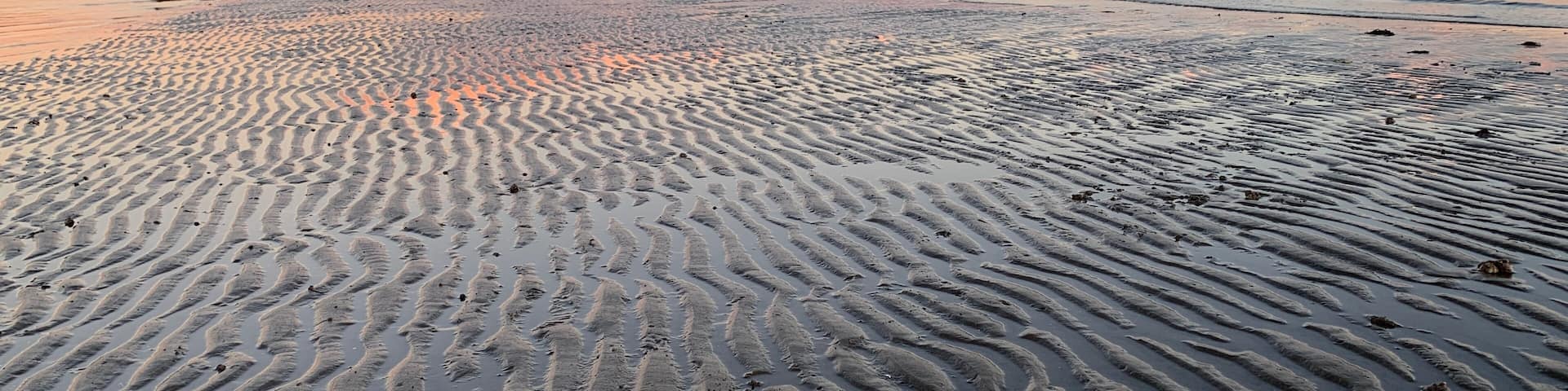Sunset looking East from Stratford CT over the sands of lowtide and Long Island Sound