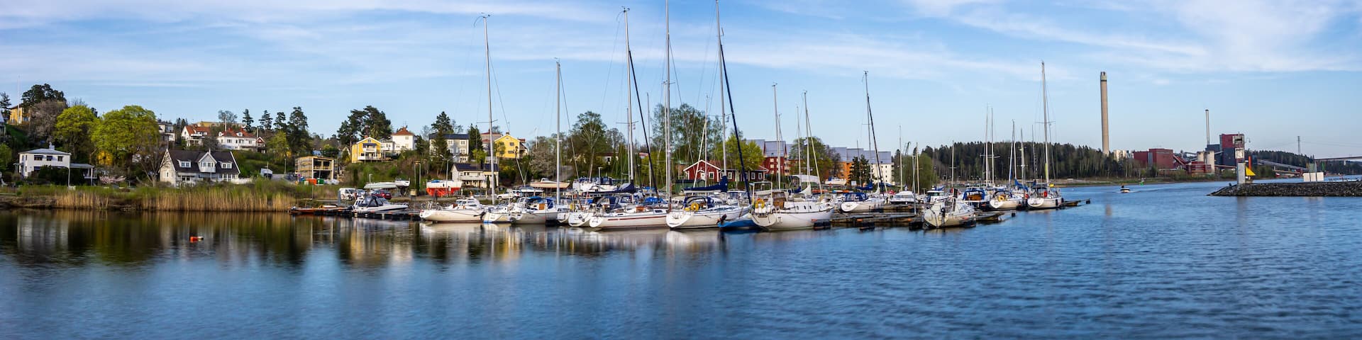 Sodertalje, Sweden - May 11, 2021: Panoramic view on the harbour in Igelsta in Sodertalje with sailboats on sunny afternoon in May