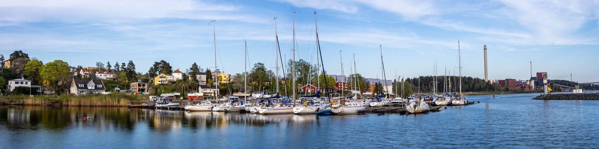 Sodertalje, Sweden - May 11, 2021: Panoramic view on the harbour in Igelsta in Sodertalje with sailboats on sunny afternoon in May