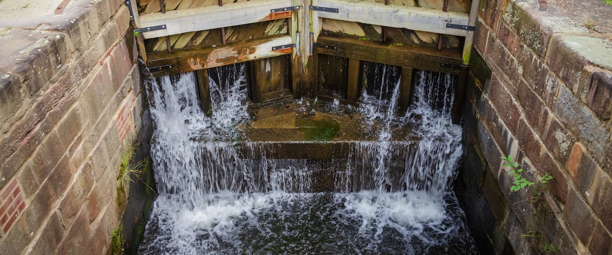 A wooden structure with a water channel underneath.