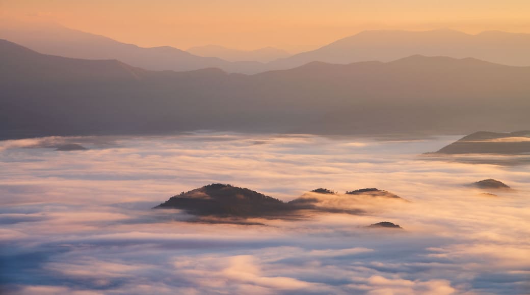 A mountain range with a valley of clouds below.