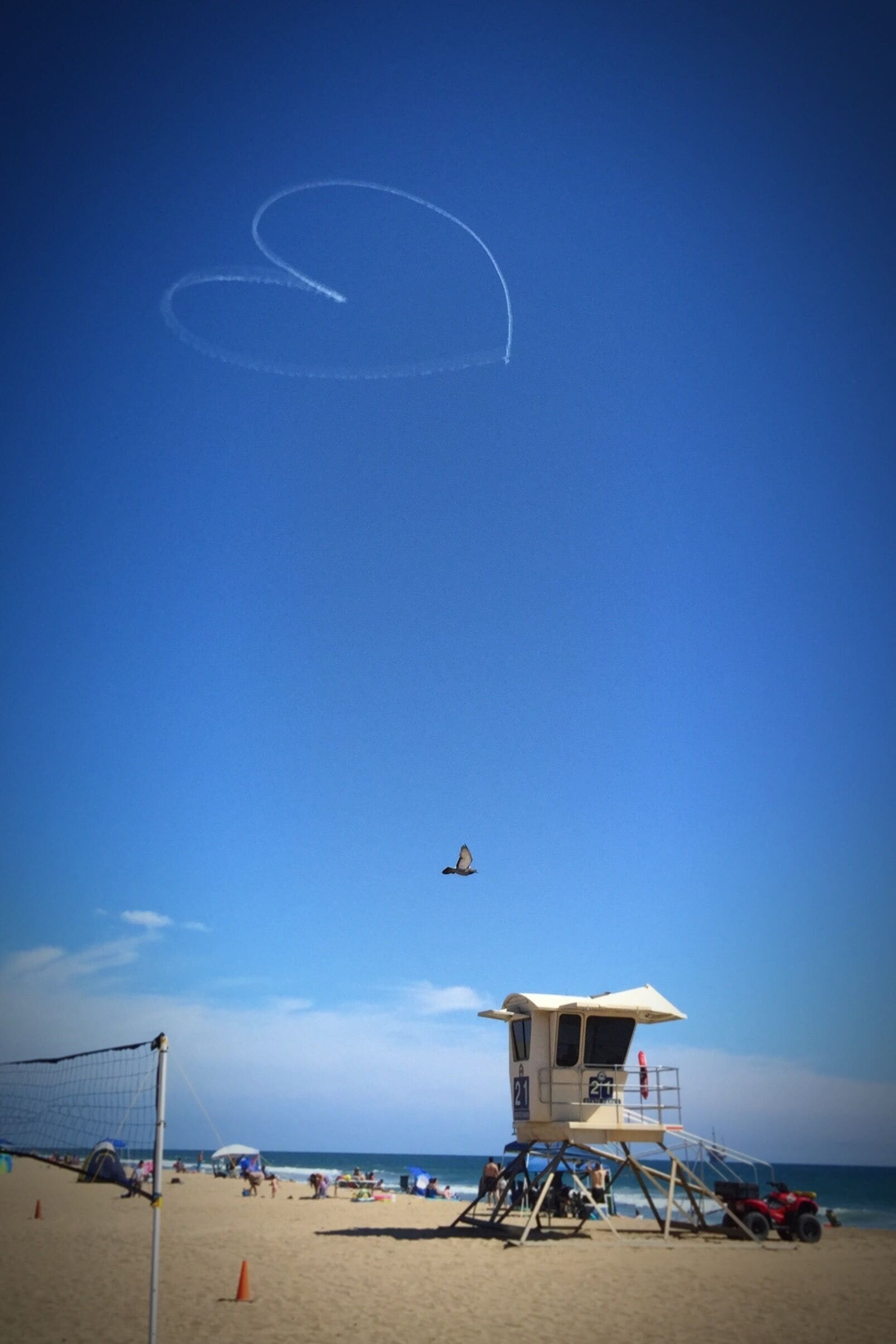 An interesting moment at the beach. This shot was taken just as a sky writer completed a nicely symmetrical heart just above lifeguard tower 21. #Waterlust Photo Challenge