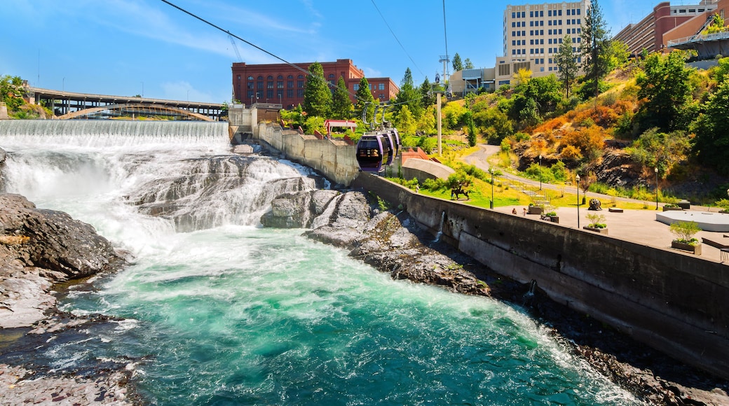 Gondolas pass over the Spokane River and Lower Falls at Huntington Park in downtown Riverfront Park, Spokane Washington State.