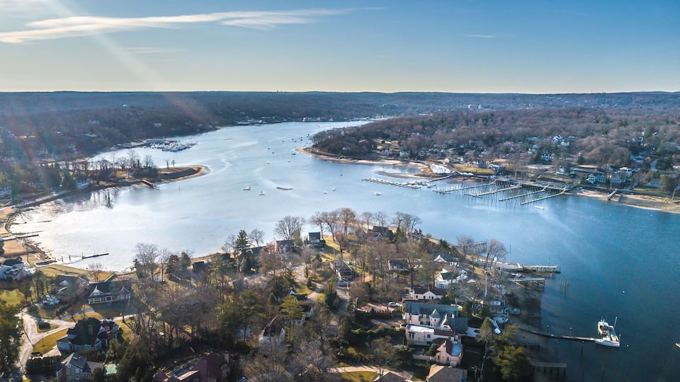 A river with boats, a marina, and residential areas.