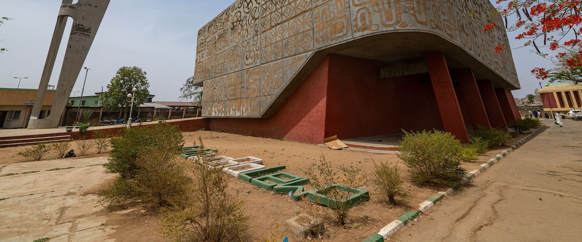 A modern building with intricate geometric patterns and a unique curved design.