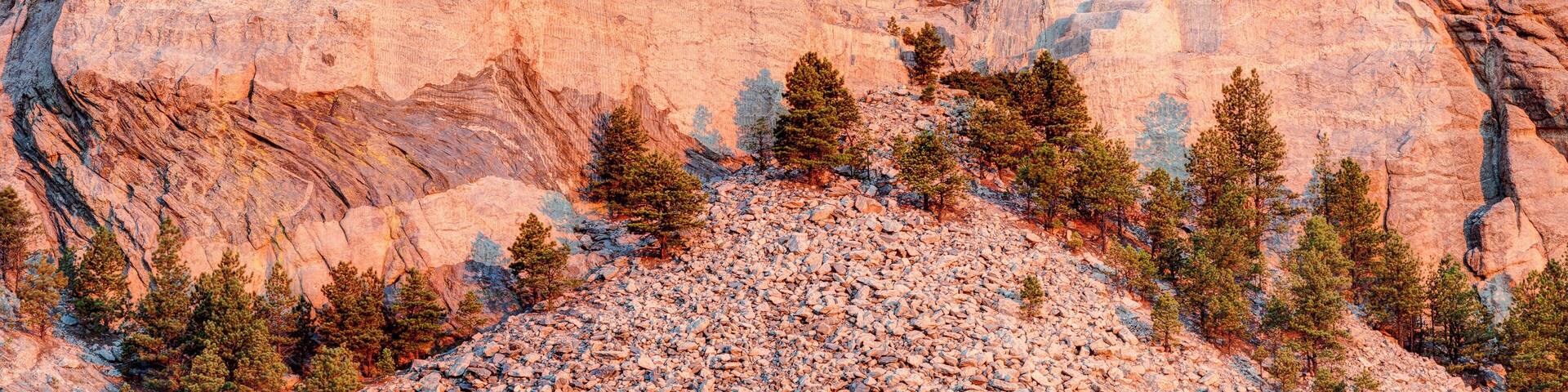 Mount Rushmore National Memorial on a clear blue sunny morning during sunrise showing all four presidents faces in HDR.