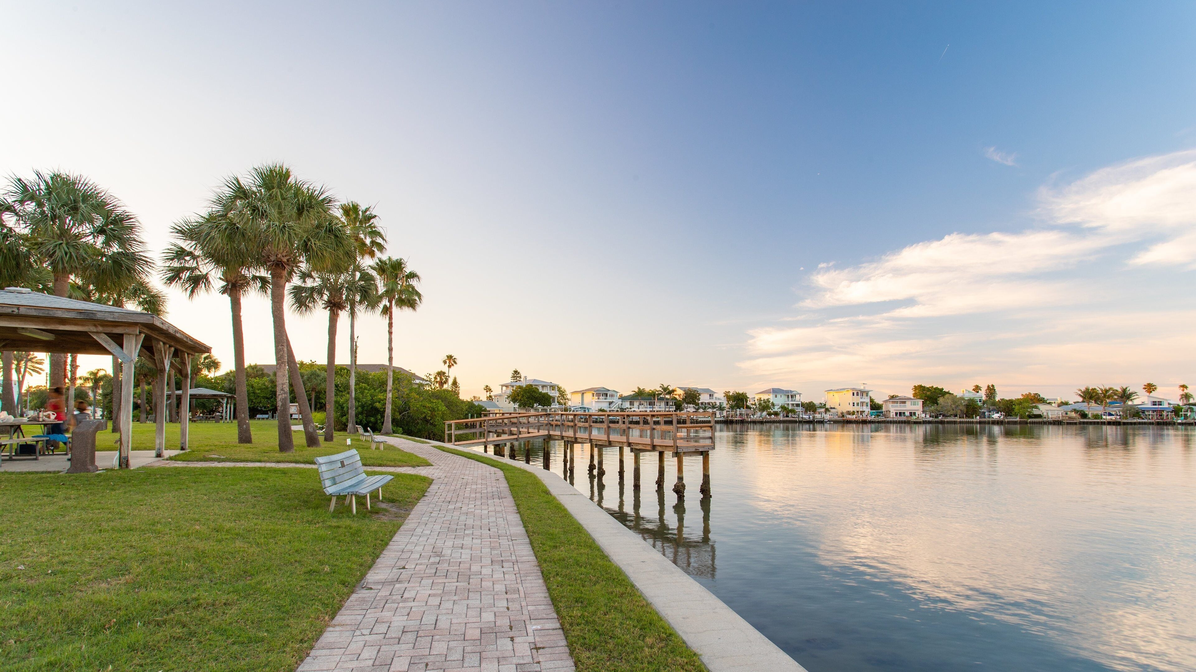 Sunset Reef which includes a park and a bay or harbor