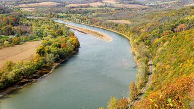 The aerial view of the Susquehanna River surrounded by striking color of fall foliage near Wyalusing, Pennsylvania, U.S