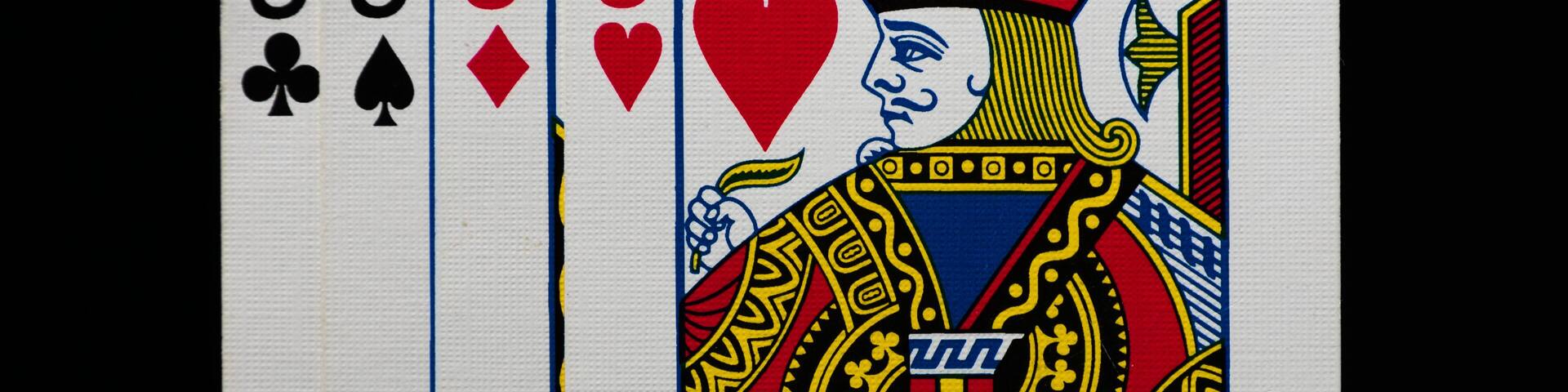 Four playing cards: three Jacks and one King of hearts.