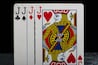 Set of four Jacks from a deck of playing cards, arranged in a row. A classic card combination symbolizing strategy, luck, and the excitement of card games.